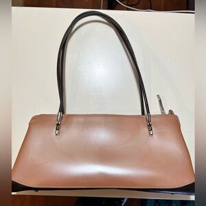 Beijo east west vinyl beige shoulder bag with fabric interior zip top, feet.